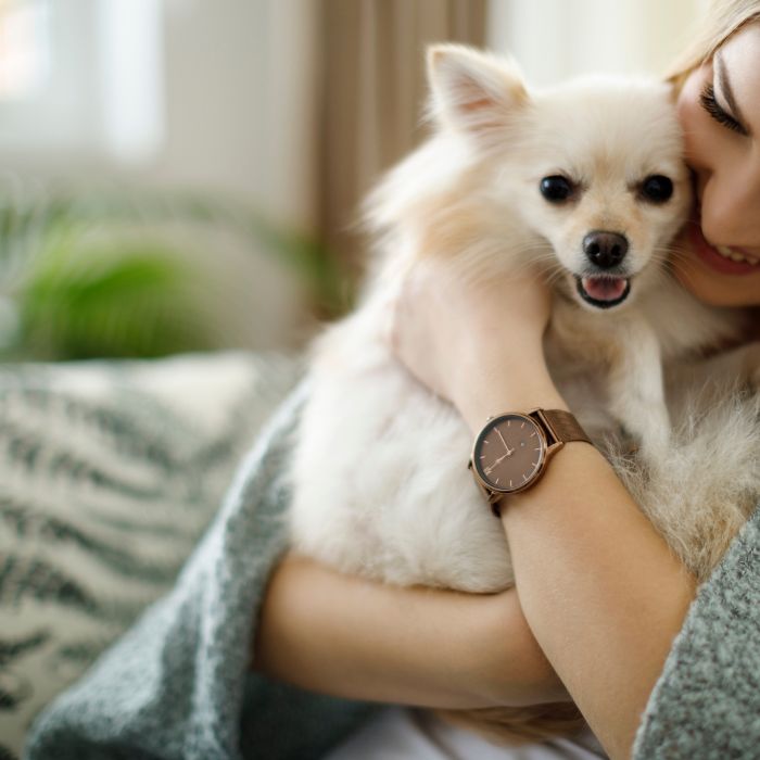Woman cuddling with her dog